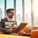 Real Estate agent discussing listings with client in stylish office space.