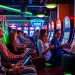 Kode4d slot gaming scene with players enjoying vibrant online slot machines.