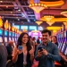 Permainan slot deposit pulsa menarik dengan pemain bersemangat di kasino yang hidup.