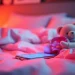 ai sexting in a cozy chat environment with a glowing smartphone on a plush bed, inviting and romantic.