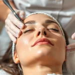 Performing Anti-aging facial Queens NY on a client in a tranquil spa environment.